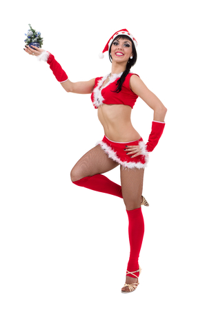 Young dancer woman in christmas hat posing on white backgroundの写真素材