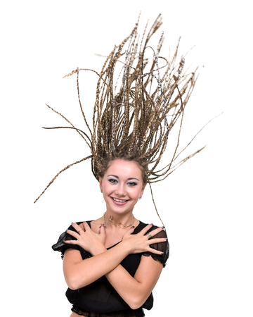 portrait of young smiling woman with flying hair dreadlocks.の写真素材
