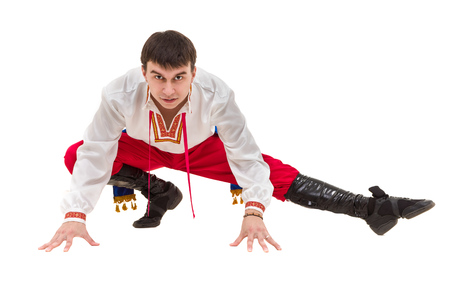 young man wearing a folk costume posing against isolated white with copyspaceの写真素材