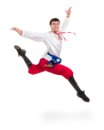 young man wearing a folk costume jumping against isolated white with copyspaceの写真素材