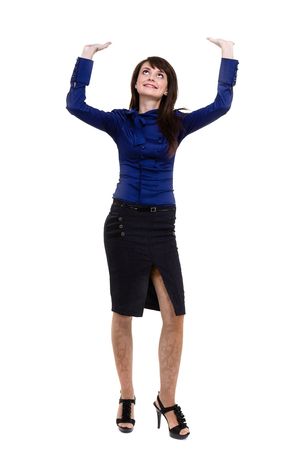 Business woman touching something, studio portrait standing full length isolated on white backgroundの写真素材