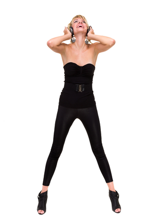 full length photo of attractive woman dancer with headphones, isolated on whiteの写真素材