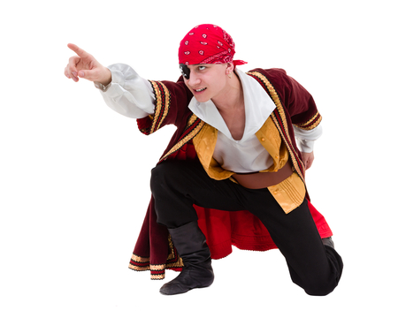man wearing a pirate costume posing with pointing gesture, isolated on whiteの写真素材
