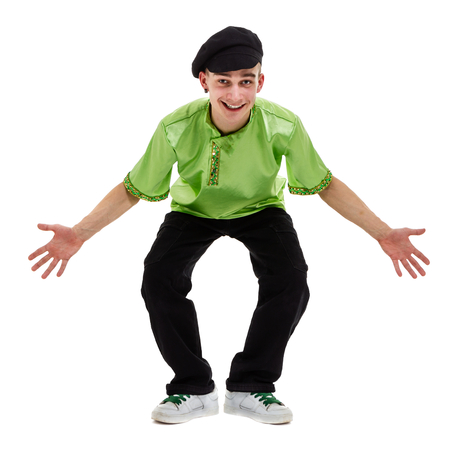 young man wearing a folk costume dancing against isolated white background with copyspaceの写真素材