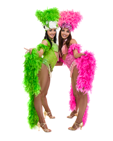 two carnival dancer women dancing against isolated white backgroundの写真素材
