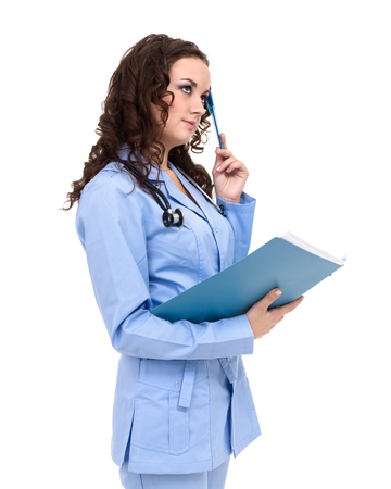 Pensive woman doctor or nurse with copy space for text. Caucasian female model isolated over white background.の写真素材