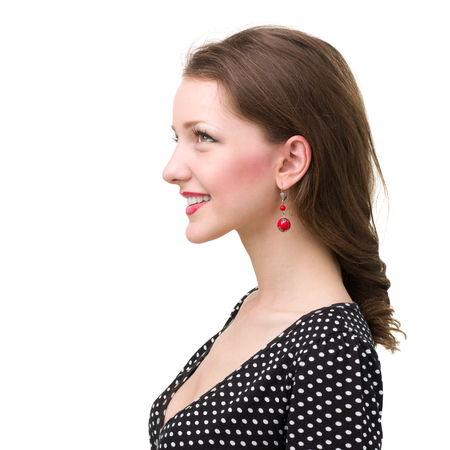 Profile portrait of young smiling woman, isolated on whiteの写真素材