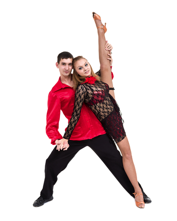 Full length of young ballet couple dancing against isolated whiteの写真素材
