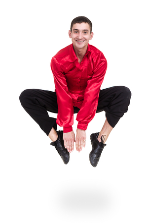 Disco dancer jumping against isolated whiteの写真素材