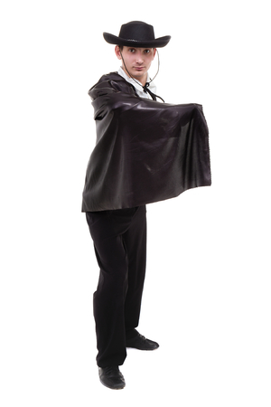 man wearing a zorro costume posing, isolated on whiteの写真素材