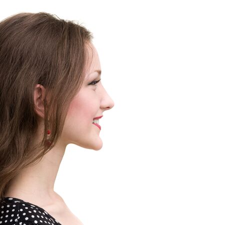 Profile portrait of young smiling woman, isolated on whiteの写真素材