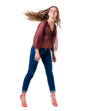 Full length portrait of coquettish female in jeans isolated on whiteの写真素材