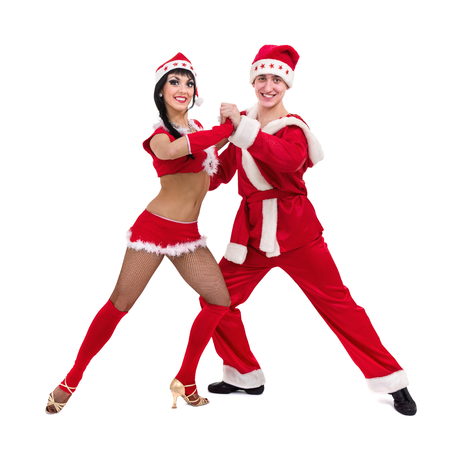 Happy young couple wearing santa claus clothesの写真素材