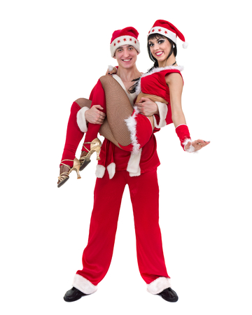 Happy young couple wearing santa claus clothesの写真素材