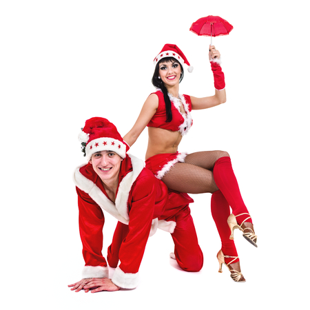 Happy young couple wearing santa claus clothesの写真素材