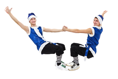 two Christmas men in blue santa clothes dancing against isolated white in full length.の写真素材
