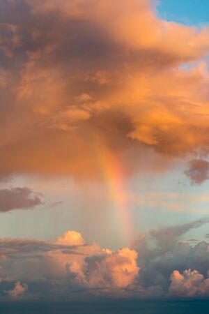 Rainbow and fantastic clouds at sunsetの写真素材