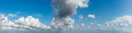 Fantastic clouds against blue sky, panoramaの写真素材