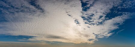 Fantastic clouds against blue sky, panoramaの写真素材