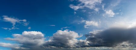 Fantastic clouds against blue sky, panoramaの写真素材