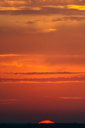 Fantastic clouds at sunrise, vertical panoramaの写真素材