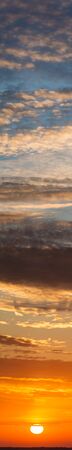 Fantastic clouds at sunrise, vertical panoramaの写真素材
