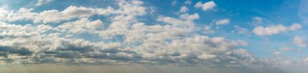 Fantastic clouds against blue sky, panorama