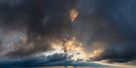 Fantastic dark thunderclouds at sunriseの写真素材
