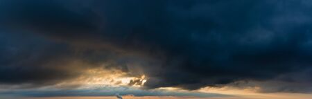 Fantastic dark thunderclouds at sunriseの写真素材