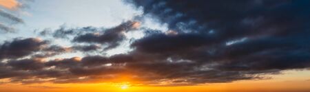 Fantastic dark thunderclouds at sunriseの写真素材