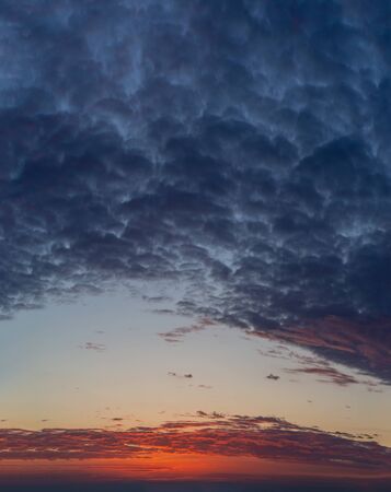 Fantastic clouds at sunrise, vertical panoramaの写真素材