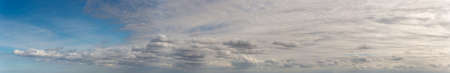 Fantastic clouds against blue sky, panorama