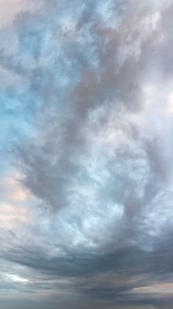 Fantastic clouds at sunrise, vertical panoramaの写真素材