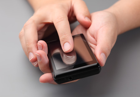 Woman's hands using a smart phone.の写真素材