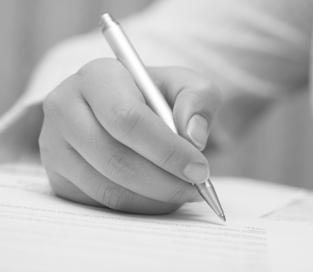 Businesswoman signing contract. Black and White image.の写真素材