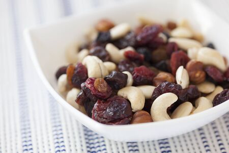 Dried nuts and berries mix in a bowl.の写真素材