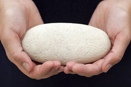 Woman's hands hold stone.You can add your text on stone.