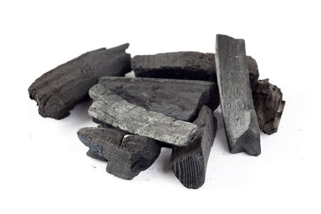 Charcoal heap on a white background.の写真素材