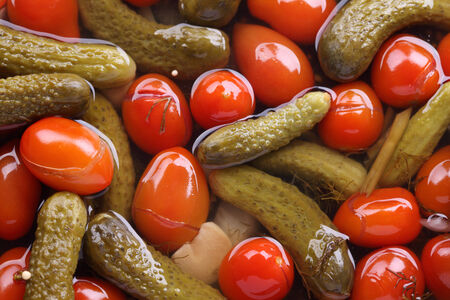 Pickled (marinated) tomatoes and cucumbers background. Close-up.の写真素材