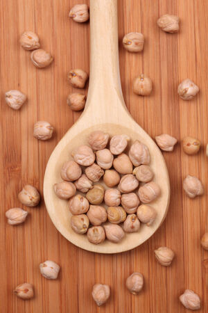 Chickpeas in a wooden spoon. Close-up.の写真素材