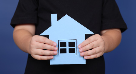 Paper House in child's hands.の写真素材