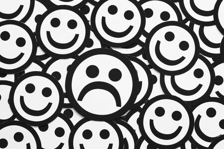 Sad face and happy faces. Concept image. Black and White. Close-up.の写真素材