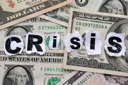Financial crisis. Word Â«CrisisÂ» on dollar banknotes.の写真素材