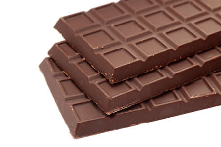 Three Chocolate bars on white background. Shallow depth of field. Close-up.