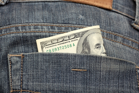 One hundred dollars in the back pocket of your jeans. Close-up.の写真素材