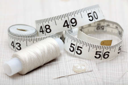 Sewing series. Tape measure and spool with needle on shirt. Close-up.EOS 5D Mark II.