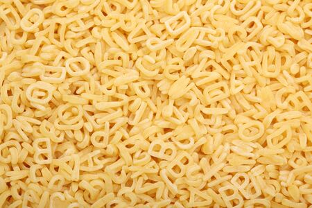 Raw alphabet soup pasta. Close-up.の写真素材