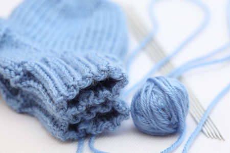 Wool knitted socks, yarn and knitting needles. Shallow depth of field. Close-up.