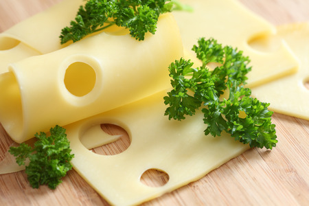 Slices of cheese and parsley. Close-up.の写真素材