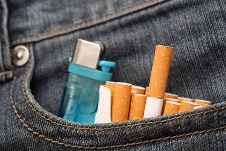 Pack of cigarettes and lighter in pocket of jeans. Close-up.の写真素材